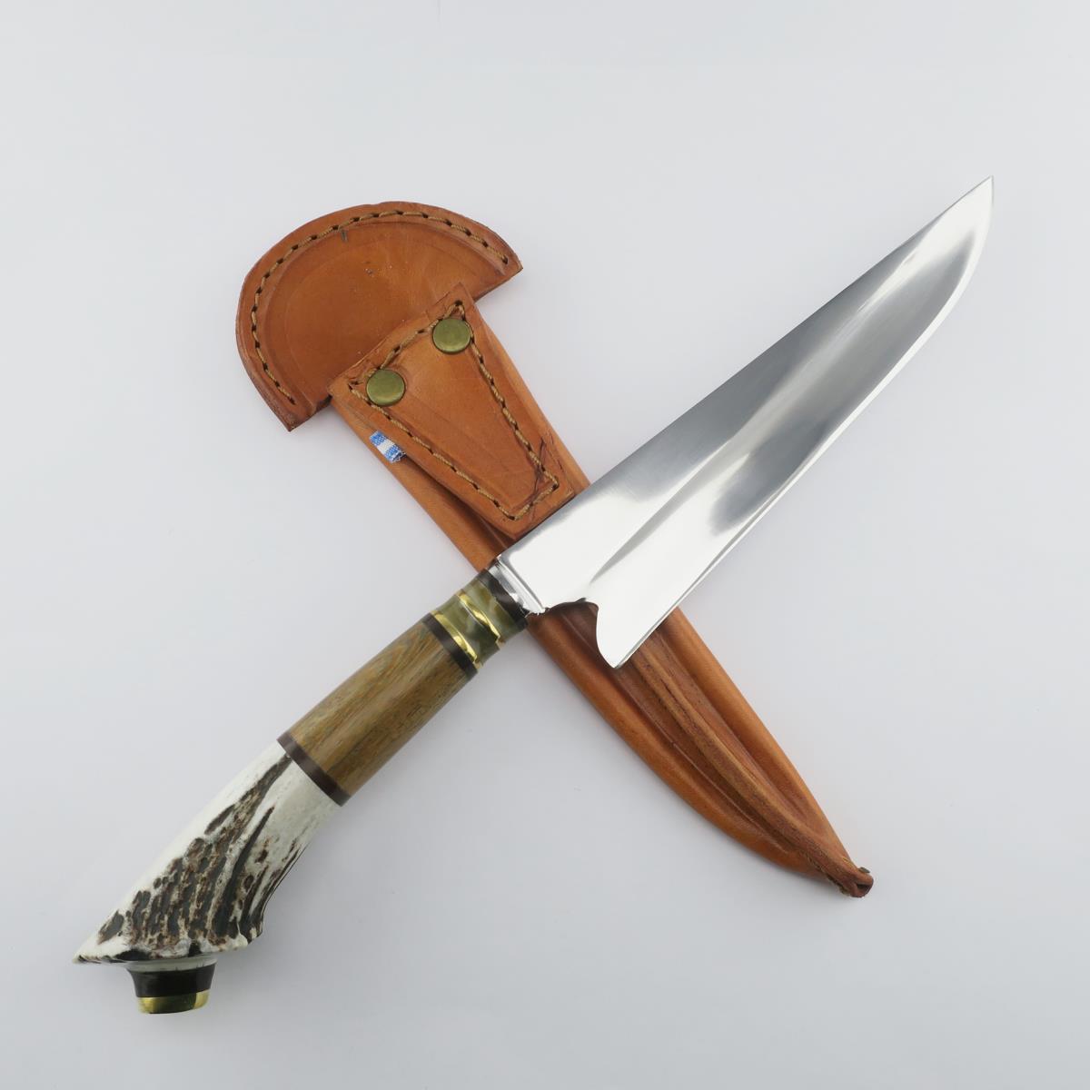 Deer antler handled knife with a stainless steel blade and a custom leather sheath, perfect for hunting, camping, or as a collector's item.