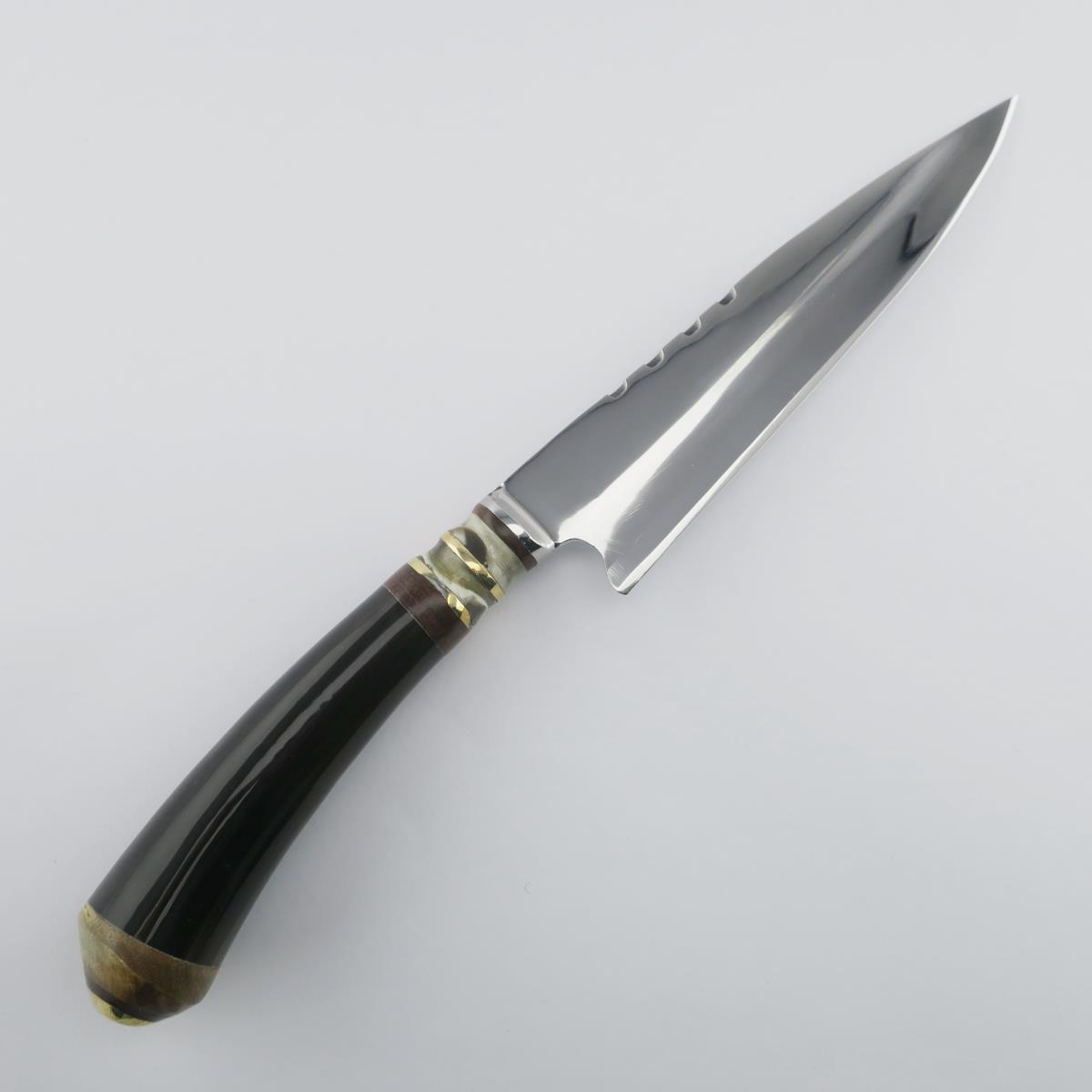 Cow 5.5in Dark stainless steel knife, perfect for kitchen use. This durable and sharp knife features a dark handle and a polished blade, ideal for various culinary tasks.