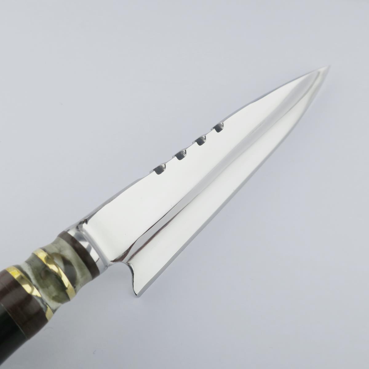 Close-up of a Cow 5.5in Dark stainless steel knife, showcasing its polished blade with unique serrations and a decorative handle made of light and dark segments with gold-colored rings.