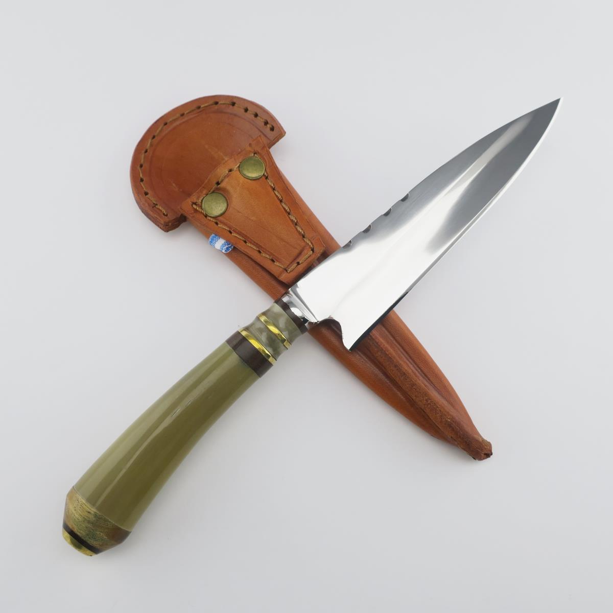 Cow 5.5in Light stainless steel knife with a polished blade and a green handle, resting on a tan leather sheath with brass rivets, against a clean white background.