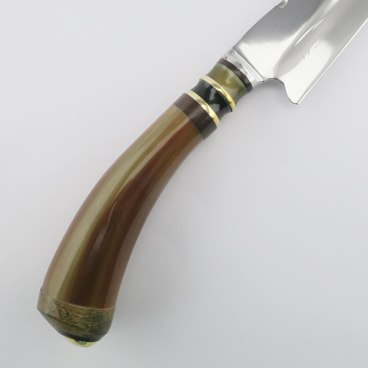 Close-up of a Cow 5.5in Combined stainless steel knife with a polished blade and a natural horn handle featuring decorative brass and dark wood rings. Ideal for various kitchen tasks, this durable knife showcases craftsmanship and elegant design.