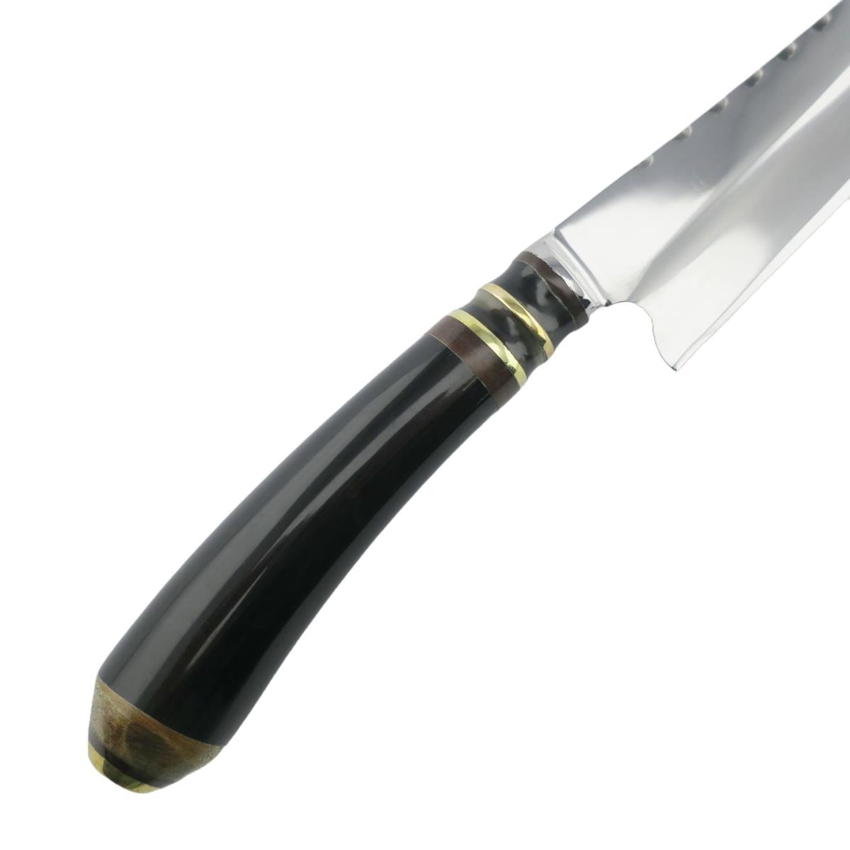 Close-up of a Cow 6.3in Dark Stainless Steel Knife with a black handle and gold accents, highlighting its sleek design and durable blade. Perfect for culinary enthusiasts and professional chefs.