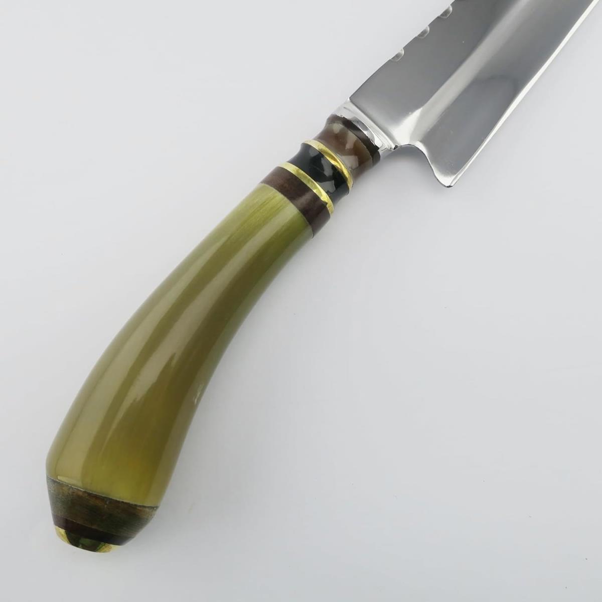 A Cow 6.3in Light knife featuring a polished stainless steel blade with a unique notched design and a distinct, curved olive green handle with black, brown, and gold accents, all set against a clean white background.